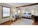 Bright bedroom showcasing wood floors, stylish furniture, and two windows offering natural light at 2025 State Road 47, Lebanon, IN 46052