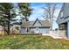 Charming blue home with a deck, white picket fence, and well-maintained lawn on a sunny day at 2025 State Road 47, Lebanon, IN 46052