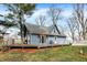 Charming blue home with a deck, white picket fence, and well-maintained lawn on a sunny day at 2025 State Road 47, Lebanon, IN 46052