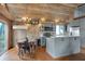 This kitchen includes a wooden ceiling, grey cabinets, stainless steel appliances, and a dining area at 2025 State Road 47, Lebanon, IN 46052