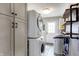 Efficient laundry room with stacked washer and dryer, white cabinets, and unique shelving for organization at 2025 State Road 47, Lebanon, IN 46052