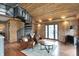 Spacious living room with wood-paneled walls, a spiral staircase, and a cozy seating area at 2025 State Road 47, Lebanon, IN 46052