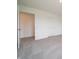 This neutral carpeted bedroom includes a closet and a door to the bathroom at 211 Ames Dr, Whiteland, IN 46184