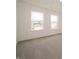 A bedroom features two windows and carpet flooring at 211 Ames Dr, Whiteland, IN 46184