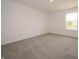 This carpeted bedroom has a large window, offering great natural light at 211 Ames Dr, Whiteland, IN 46184