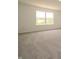 A bright bedroom features carpet flooring and a large window at 211 Ames Dr, Whiteland, IN 46184