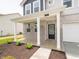Covered front porch with a brick facade and a black front door at 211 Ames Dr, Whiteland, IN 46184