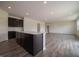 Bright kitchen with large center island, dark cabinetry, and an open-concept design at 211 Ames Dr, Whiteland, IN 46184