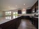 Large kitchen with dark cabinets, quartz countertops, stainless appliances, and center island at 211 Ames Dr, Whiteland, IN 46184