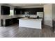 Modern kitchen with black cabinets, stainless steel appliances, an island, and hardwood flooring at 211 Ames Dr, Whiteland, IN 46184