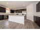 Stylish kitchen features dark cabinets, stainless appliances, and a spacious center island at 211 Ames Dr, Whiteland, IN 46184