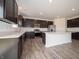 Beautiful kitchen featuring quartz countertops, dark cabinetry, and stainless steel appliances at 211 Ames Dr, Whiteland, IN 46184