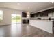 Modern kitchen boasts stainless steel appliances, dark cabinets, and a white quartz island at 211 Ames Dr, Whiteland, IN 46184