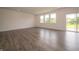 Bright living room featuring sleek hardwood floors, large windows, and a sliding glass door at 211 Ames Dr, Whiteland, IN 46184
