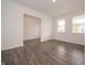 Open living space with wood floors and large windows providing natural light at 211 Ames Dr, Whiteland, IN 46184