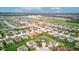 Wide aerial shot captures a residential neighborhood with sprawling green spaces and blue sky at 2209 Foxfire Ct, Greenfield, IN 46140