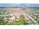 An aerial view of the neighborhood featuring a pond and surrounding residential homes and grassy yards at 2209 Foxfire Ct, Greenfield, IN 46140