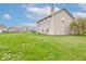 Expansive backyard featuring a well-maintained lawn and a view of the home's exterior at 2209 Foxfire Ct, Greenfield, IN 46140