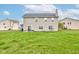 Spacious backyard featuring a well-maintained lawn, and a glimpse of the home's back exterior at 2209 Foxfire Ct, Greenfield, IN 46140