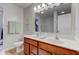 Bright bathroom with double sinks, wood look floor, and walk-in closet at 2209 Foxfire Ct, Greenfield, IN 46140