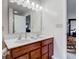 Bathroom featuring a double sink vanity, and large mirror with view to bedroom at 2209 Foxfire Ct, Greenfield, IN 46140