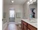 Bathroom featuring double sinks, wood look floor, and soaking tub at 2209 Foxfire Ct, Greenfield, IN 46140