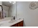 Clean half bathroom with modern fixtures, wooden vanity, and decorative wall accents at 2209 Foxfire Ct, Greenfield, IN 46140