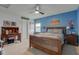 Spacious bedroom with a fan, desk, and large bed with wooden bedframe at 2209 Foxfire Ct, Greenfield, IN 46140