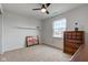This bedroom has neutral walls, plush carpeting, a ceiling fan, and a decorative fireplace at 2209 Foxfire Ct, Greenfield, IN 46140