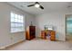 This bedroom has a ceiling fan, natural light, and space for both dresser and desk at 2209 Foxfire Ct, Greenfield, IN 46140