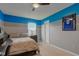 Bedroom with fan, neutral walls, a painted accent stripe, and a view to window at 2209 Foxfire Ct, Greenfield, IN 46140