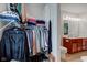 Walk-in closet leading to the bathroom with vanity sink, toilet, and hardwood floor at 2209 Foxfire Ct, Greenfield, IN 46140