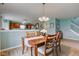 Dining room open to kitchen with wood table, chairs, and light green walls at 2209 Foxfire Ct, Greenfield, IN 46140