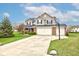 Charming two-story home with manicured lawn, three-car garage, and basketball hoop at 2209 Foxfire Ct, Greenfield, IN 46140