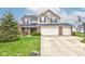 Charming two-story home with manicured lawn, three-car garage, and basketball hoop at 2209 Foxfire Ct, Greenfield, IN 46140