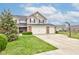 Charming two-story home with manicured lawn, three-car garage, and basketball hoop at 2209 Foxfire Ct, Greenfield, IN 46140