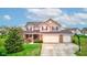 Lovely two-story home featuring a two-car garage, front yard landscaping, and a basketball hoop at 2209 Foxfire Ct, Greenfield, IN 46140