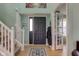 Bright foyer with wood floors, staircase, and coat closet at 2209 Foxfire Ct, Greenfield, IN 46140