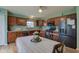 Modern kitchen with wood cabinets, stainless steel appliances, and eat-in dining area at 2209 Foxfire Ct, Greenfield, IN 46140