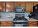 Well-equipped kitchen featuring wood cabinets, a modern range, and ample countertop space for culinary enthusiasts at 2209 Foxfire Ct, Greenfield, IN 46140