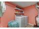 Well-equipped laundry room with modern appliances, shelving, and ample space for all laundry needs at 2209 Foxfire Ct, Greenfield, IN 46140