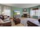 Comfortable living room with light green walls, wood floors, fireplace, and leather sofa at 2209 Foxfire Ct, Greenfield, IN 46140