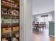 Organized pantry with wire shelving adjacent to dining room, maximizing storage and accessibility at 2209 Foxfire Ct, Greenfield, IN 46140