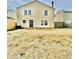 A spacious backyard featuring a yellow vinyl-sided house, a wood fence and an exterior back door at 2405 Providence Ct, Greenwood, IN 46143