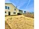 A spacious backyard featuring a yellow vinyl-sided house, a wood fence and an exterior back door at 2405 Providence Ct, Greenwood, IN 46143