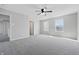 Spacious bedroom boasts neutral paint, carpet flooring, a ceiling fan, and multiple windows for ample natural light at 2405 Providence Ct, Greenwood, IN 46143
