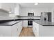 Modern kitchen with stainless steel appliances, granite countertops, and white cabinets at 2405 Providence Ct, Greenwood, IN 46143
