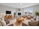 Bright living room features a fireplace, new floors, neutral paint, and multiple seating options at 2405 Providence Ct, Greenwood, IN 46143