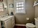 Cozy half-bath with a modern vanity, fixtures, and natural light from the window at 303 S Walnut St, Edinburgh, IN 46124