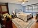 Cozy bedroom features a decorative rug, a ceiling fan, and natural light from the windows at 303 S Walnut St, Edinburgh, IN 46124